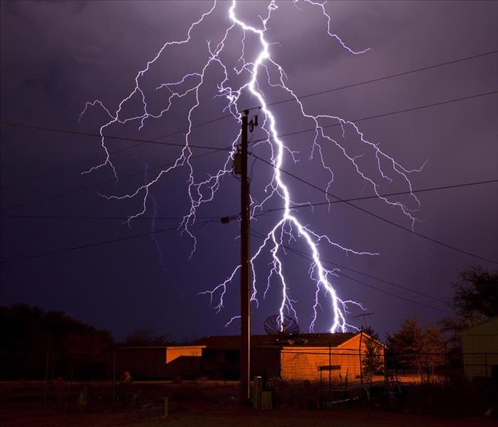 Extremely detailed lightning bolt behind electric utility pole