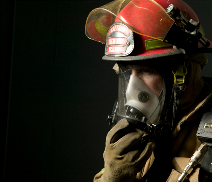 Fire fighter in full safety breathing gear