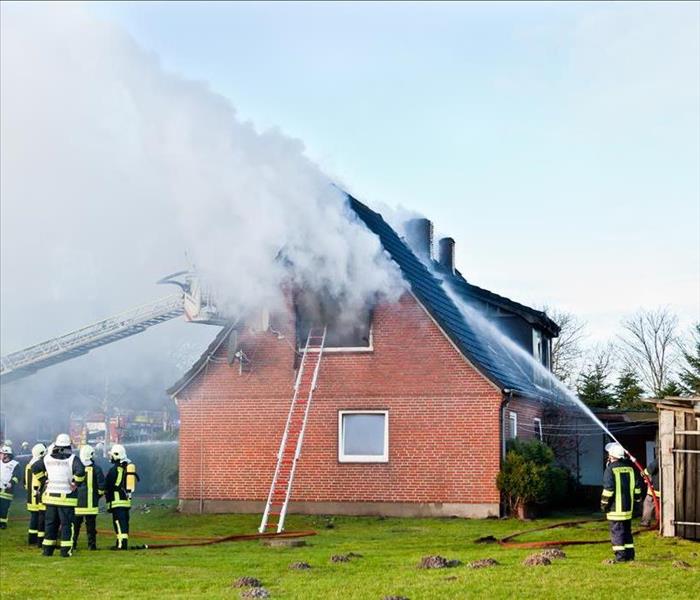 Firefighters putting out a fire in a house