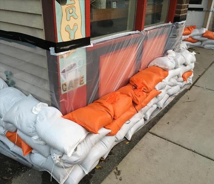 A Business protected from flooding with sand bags and plastic film. 